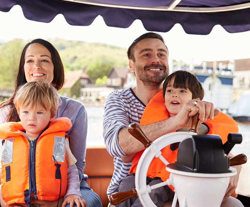 Family driving a boat covered with boat insurance in Baytown, TX
